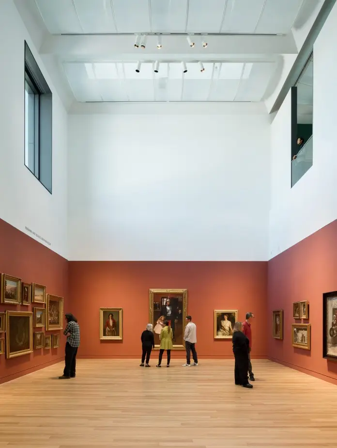 Exposición en el Palmer Museum of Art con pinturas clásicas iluminadas por lucernario y ventana.